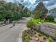 Lake Arietta Reserve community entrance with a stone and iron gate and landscaped garden at 148 Melissa Trl, Auburndale, FL 33823