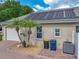 Side exterior of home with solar panels, a paved driveway, trash cans, and a well-maintained exterior at 148 Melissa Trl, Auburndale, FL 33823