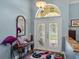Home foyer features colorful rug, glass paneled front door, and decorative mirror at 148 Melissa Trl, Auburndale, FL 33823