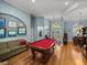 This game room features a red felt pool table and gives access to an office and front entry at 148 Melissa Trl, Auburndale, FL 33823
