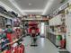 Large garage featuring a motorcycle lift, work benches, and ample storage space for tools and equipment at 148 Melissa Trl, Auburndale, FL 33823