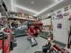 This garage is designed with a motorcycle lift, ample storage, workbench, and themed decor for motorcycle maintenance at 148 Melissa Trl, Auburndale, FL 33823