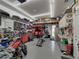 Garage with a motorcycle lift, tool storage, workbenches and storage overhead at 148 Melissa Trl, Auburndale, FL 33823