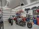 A detailed garage featuring ample space for several motorcycles and a variety of tools and storage options at 148 Melissa Trl, Auburndale, FL 33823