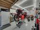 A well-lit garage equipped with a motorcycle lift, tool storage, and ample space for motorcycle maintenance at 148 Melissa Trl, Auburndale, FL 33823