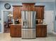 Kitchen featuring stainless steel refrigerator, wooden cabinets, and tile backsplash at 148 Melissa Trl, Auburndale, FL 33823