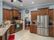 Kitchen featuring stainless appliances, custom cabinets, tiled backsplash, and an eat-in counter with barstools at 148 Melissa Trl, Auburndale, FL 33823