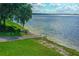 Scenic lake access area with a boat ramp, lush green grass, and calm water at 148 Melissa Trl, Auburndale, FL 33823