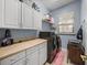 Laundry room with washer, dryer, and plenty of cabinet space and folding area at 148 Melissa Trl, Auburndale, FL 33823