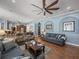 Spacious living area with open floor plan, connecting to the kitchen and dining area at 148 Melissa Trl, Auburndale, FL 33823