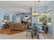Living room and dining area with an overhead fan, tile flooring, and view of the pool area at 148 Melissa Trl, Auburndale, FL 33823