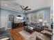 Comfortable living room with large windows, a ceiling fan, and plenty of seating at 148 Melissa Trl, Auburndale, FL 33823