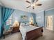 Comfortable main bedroom with a ceiling fan, light blue walls, two upholstered chairs, and two windows at 148 Melissa Trl, Auburndale, FL 33823