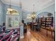 Bright home office with wooden floors, large bookshelves and a colorful rug near the front door at 148 Melissa Trl, Auburndale, FL 33823