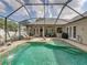 A screened pool with lounge chairs and outdoor seating offers a relaxing entertainment space at 148 Melissa Trl, Auburndale, FL 33823