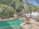 Gorgeous screened-in pool with a rock waterfall feature and inviting patio area at 148 Melissa Trl, Auburndale, FL 33823