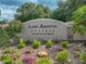 Lake Arietta Reserve sign with beautiful landscaping and colorful flowers in a well maintained community at 148 Melissa Trl, Auburndale, FL 33823