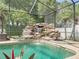 The screened in pool features a rock waterfall feature, adding to a tropical paradise at 148 Melissa Trl, Auburndale, FL 33823