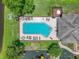 Overhead view of the community pool, playground, and lounge chairs next to a neighborhood pond at 1547 Cordgrass Way, Lakeland, FL 33813