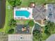 Aerial view featuring a community pool, playground, clubhouse, parking and surrounding green spaces at 1547 Cordgrass Way, Lakeland, FL 33813
