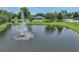 Aerial view of the community with a fountain pond, clubhouse, pool, playground, and surrounding landscaping at 1547 Cordgrass Way, Lakeland, FL 33813