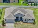 Aerial view of a well maintained home with a spacious backyard and pool nearby at 1547 Cordgrass Way, Lakeland, FL 33813
