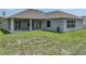 The house features a covered lanai and a large yard with lush green grass at 1547 Cordgrass Way, Lakeland, FL 33813
