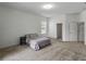 Bright bedroom with carpet, window, and neutral decor for a minimalist design at 1547 Cordgrass Way, Lakeland, FL 33813