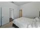 Bedroom featuring a bed, and doorways leading to a bathroom and closet at 1547 Cordgrass Way, Lakeland, FL 33813