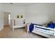 Bright bedroom featuring two twin beds and whimsical wall art at 1547 Cordgrass Way, Lakeland, FL 33813
