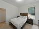 Bedroom featuring a wood framed bed, two wooden nightstands, and window with shade at 1547 Cordgrass Way, Lakeland, FL 33813