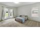 Bright bedroom with carpeted floor, window, and French doors leading to outdoor space at 1547 Cordgrass Way, Lakeland, FL 33813