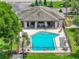 Community pool with ample seating, shaded patio, and easy access to clubhouse amenities at 1547 Cordgrass Way, Lakeland, FL 33813