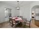 Bright dining room features modern lighting, a window and an entryway to another room at 1547 Cordgrass Way, Lakeland, FL 33813