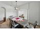 Bright dining room with contemporary lighting, carpeted floor and columned archway at 1547 Cordgrass Way, Lakeland, FL 33813