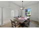 Bright dining room offers contemporary lighting, a window view, and archway entrances at 1547 Cordgrass Way, Lakeland, FL 33813
