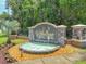 Elegant community entrance featuring a stone monument, decorative fountain, and lush landscaping, creating a welcoming ambiance at 1547 Cordgrass Way, Lakeland, FL 33813