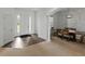 Open-concept foyer with sightlines to a dining area and front door with sidelights at 1547 Cordgrass Way, Lakeland, FL 33813
