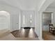 Bright foyer featuring wood-look flooring, high ceilings, and a view into other rooms at 1547 Cordgrass Way, Lakeland, FL 33813