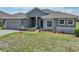 Charming single story home featuring a manicured front lawn and stone accents at 1547 Cordgrass Way, Lakeland, FL 33813
