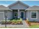 Charming front entrance with well-manicured landscaping and stone column accents at 1547 Cordgrass Way, Lakeland, FL 33813