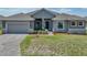 Beautiful single-story home with a two-car garage, stone accents, and a well-maintained lawn at 1547 Cordgrass Way, Lakeland, FL 33813