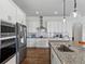 Bright, modern kitchen with white cabinets, stainless steel appliances, and granite countertops at 1547 Cordgrass Way, Lakeland, FL 33813
