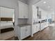 Modern kitchen with granite countertops, white cabinets and stainless-steel range hood at 1547 Cordgrass Way, Lakeland, FL 33813