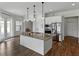 Kitchen island with granite countertop, stainless appliances and view to living room at 1547 Cordgrass Way, Lakeland, FL 33813