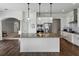 Open-concept kitchen with a large island, stainless appliances and white cabinets at 1547 Cordgrass Way, Lakeland, FL 33813