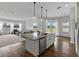 Open concept kitchen with granite island, stainless dishwasher and view to backyard at 1547 Cordgrass Way, Lakeland, FL 33813