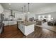 Gourmet kitchen with granite island and stainless appliances overlooks the living room at 1547 Cordgrass Way, Lakeland, FL 33813