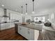 Modern kitchen with pendant lighting over the island and stainless steel appliances at 1547 Cordgrass Way, Lakeland, FL 33813