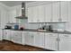 Modern kitchen with granite countertops, white cabinets and stainless-steel range hood at 1547 Cordgrass Way, Lakeland, FL 33813